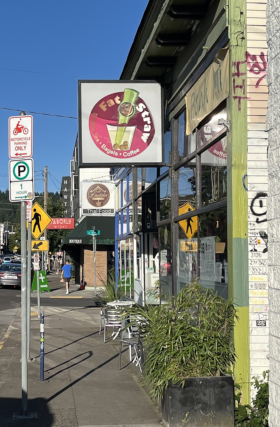 Portrait storefront and sidewalk, Fat Straw sign visible